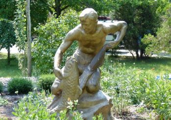 Monument young man with a towel and fish, Berdyansk